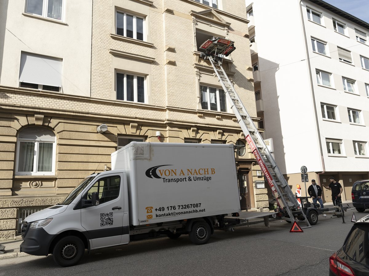 Umzugswagen von Von A nach B mit aufgestelltem Möbellift vor einem Altbau in Stuttgart